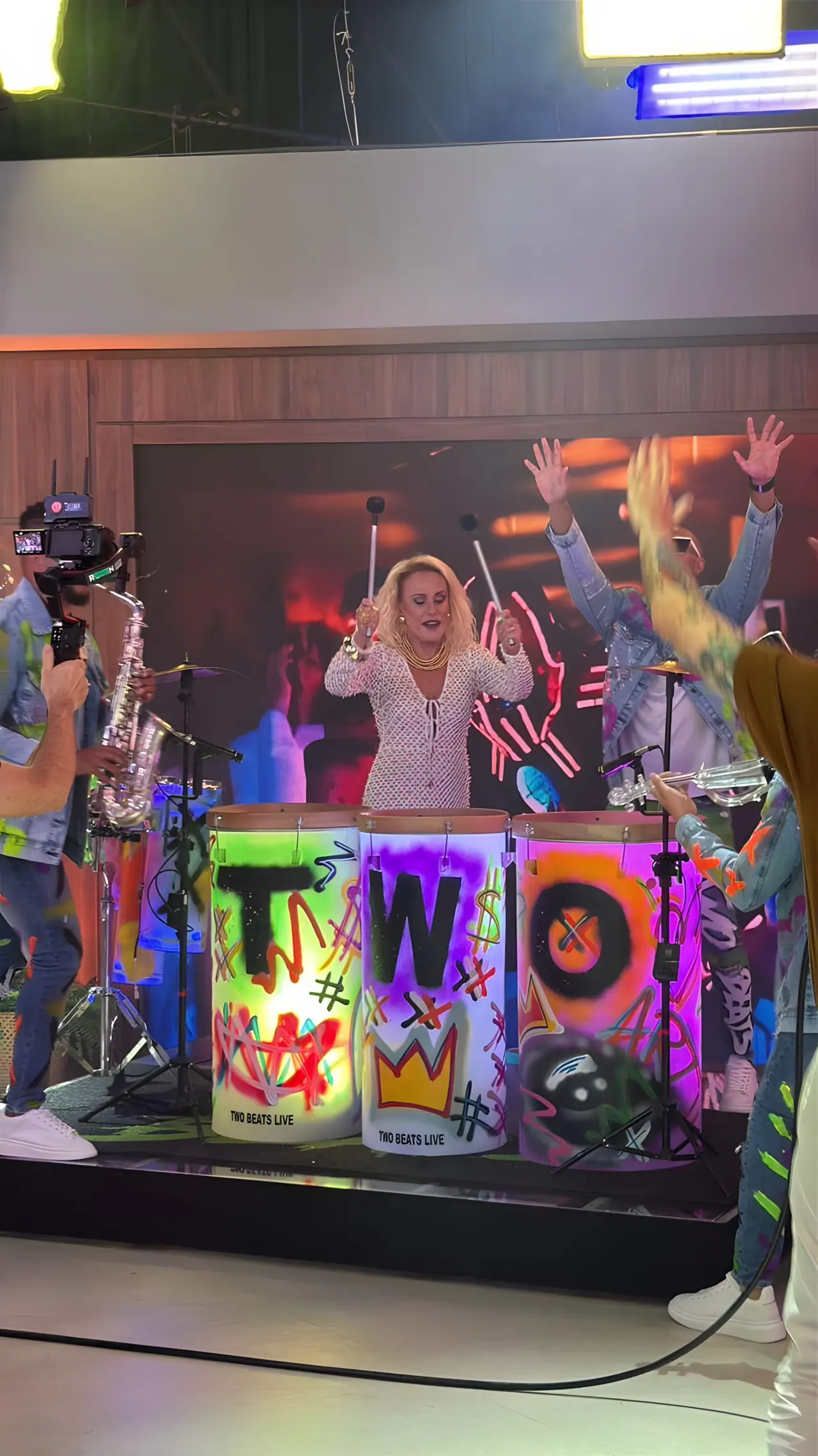 Ana Maria Braga tocando os tambores grafitados da Two Beats no programa